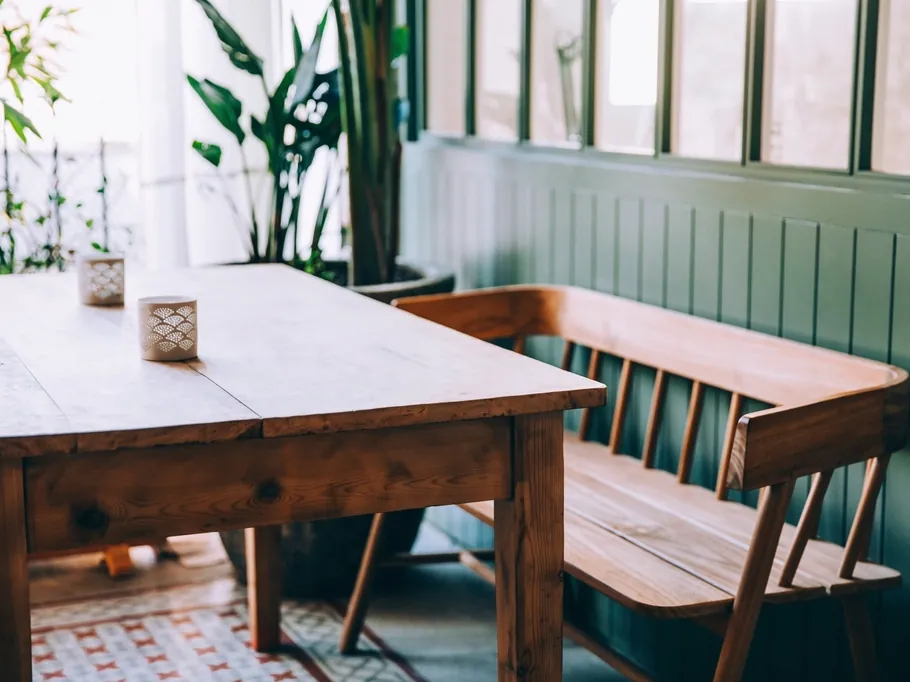 Sample photo: wooden table and bench in a sunny room.